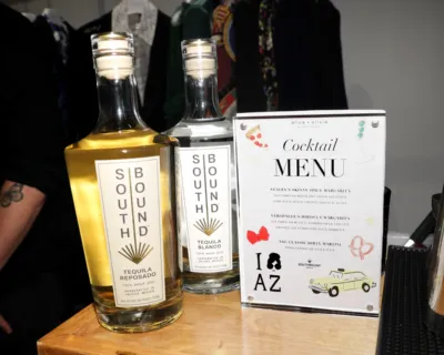 Southbound Tequila Reposado and Blanco bottles displayed next to a custom cocktail menu at an Alice + Olivia event by The Bond Bar in Scottsdale, Arizona.