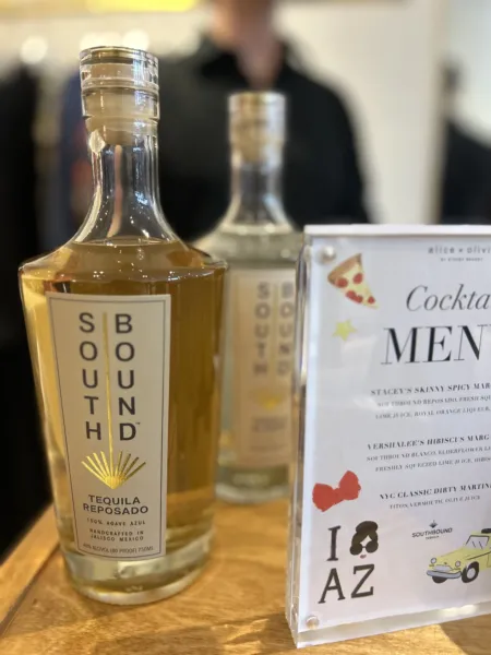 Southbound Tequila Reposado and Blanco bottles displayed next to a custom cocktail menu at an Alice + Olivia event by The Bond Bar in Scottsdale, Arizona.