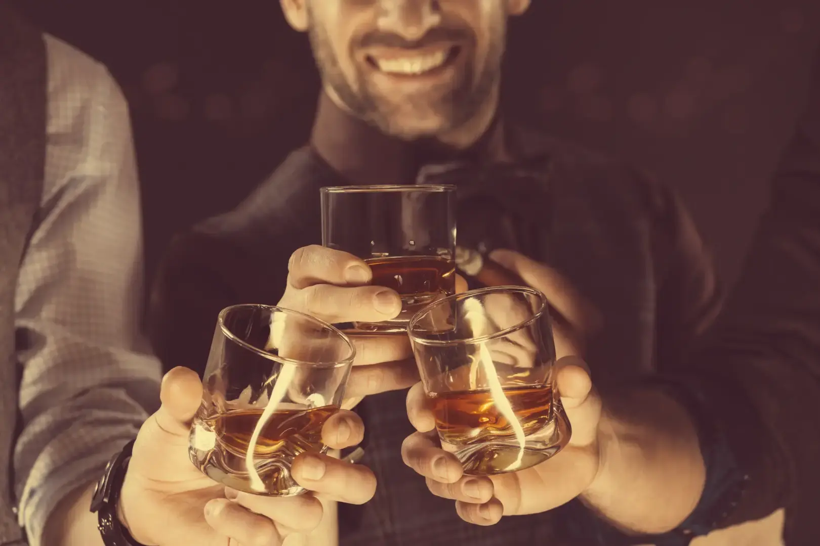 Groomsmen toasting whiskey in celebration