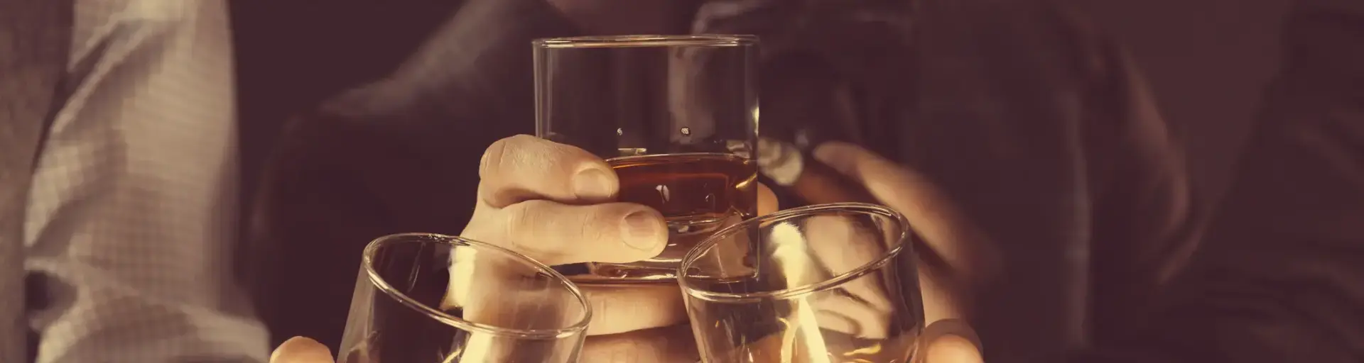Groomsmen toasting whiskey in celebration